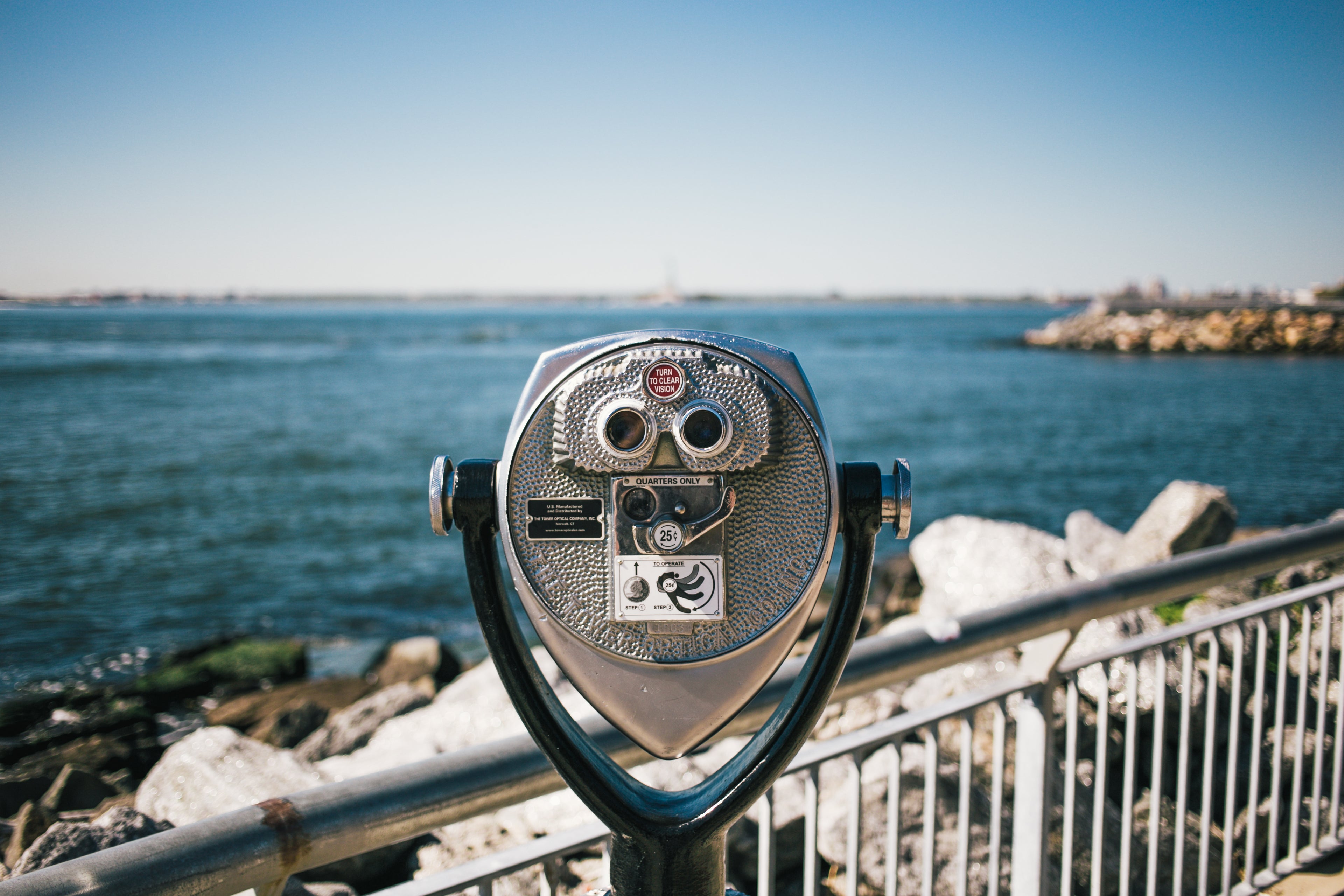 Coin-operated binoculars at a small bridge looking out at the ocean