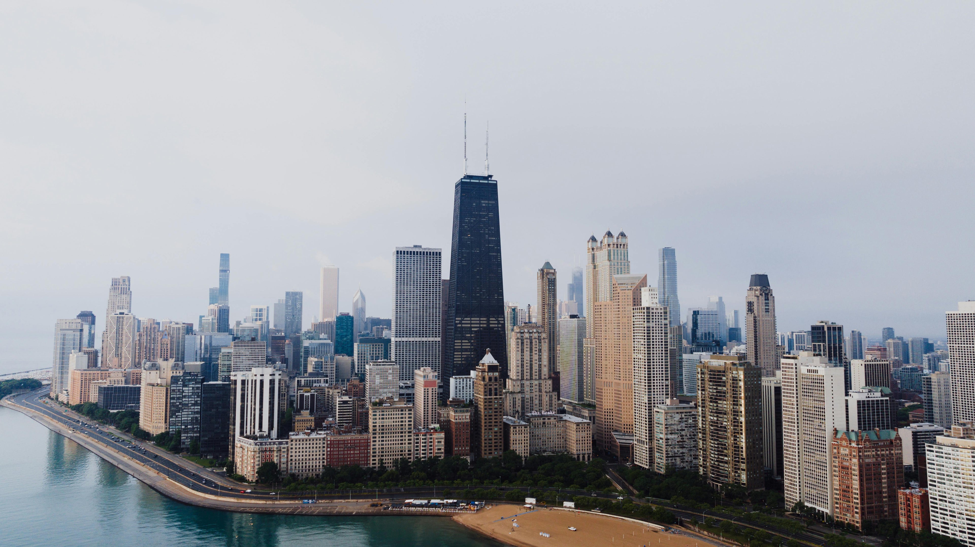 Chicago skyline with lake to left. Photo by Kelly: https://www.pexels.com/photo/skyscrapers-in-chicago-26821672/