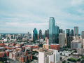 Dallas skyline from a distance during the day. Photo by Huihui Zhang: https://www.pexels.com/photo/aerial-photo-of-city-buildings-2051002/