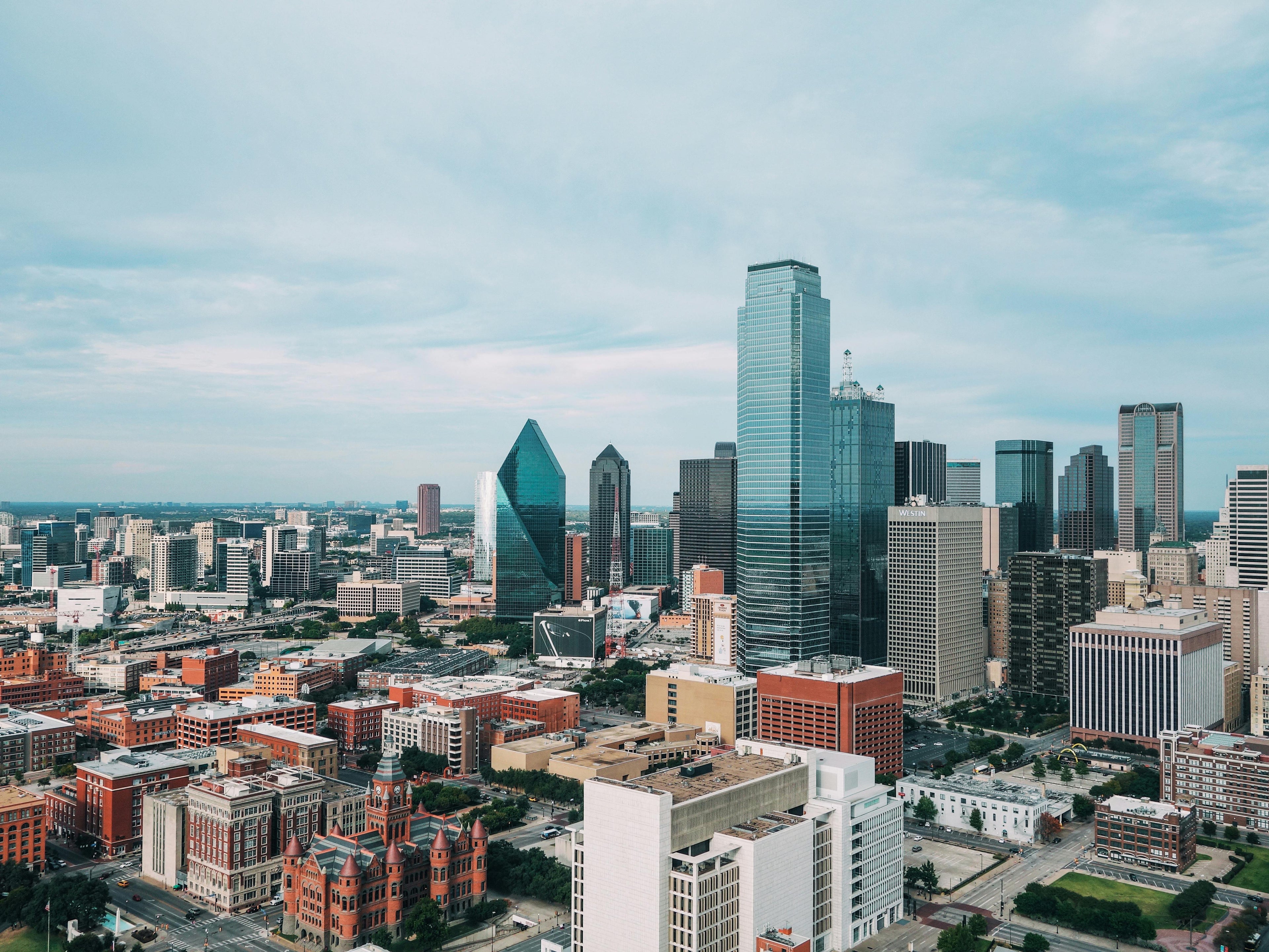 Dallas skyline from a distance during the day. Photo by Huihui Zhang: https://www.pexels.com/photo/aerial-photo-of-city-buildings-2051002/